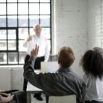 People Having a Discussion in a White Room